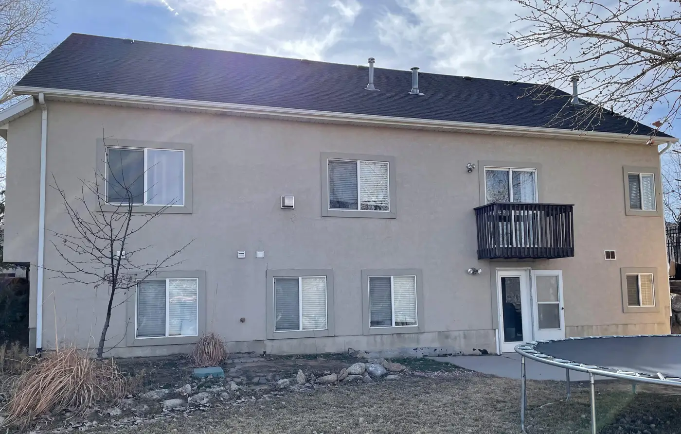 Stucco weathered and cracked on rear of home